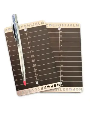 2 Steel seed phrase backup plate with engraved A–Z and 1–24 grid – shown next to engraving tool